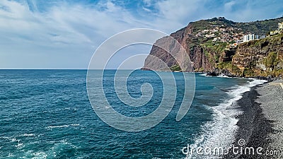 Panoramic view of Praia de Vigario in Camara de Lobos on Madeira island, Portugal, Europe. Black stone beach in Atlantic Ocean Stock Photo