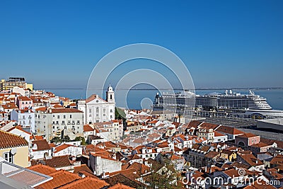 Panoramic view on red roofs on Lisbon centre and big cruise liner ship on Tagus River Stock Photo