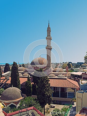 Panoramic view of rhodes town with the dome and minaret of the Suleiman mosque and city buildings against a blue summer sky Stock Photo