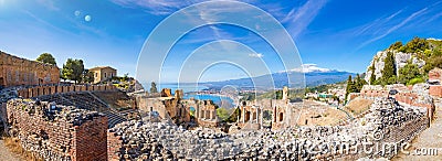 Panoramic view of ruins of Ancient Greek theatre in Taormina on background of Etna Volcano, Italy Stock Photo