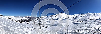 Panoramic view of ski resort, slope, people on the ski lift, skiers on the piste in Valle Nevado Editorial Stock Photo