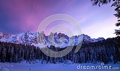 Panoramic view of snow covered lake carezza lago di carezza, karersee and latemar in winter; unesco world heritage, dolomites Stock Photo