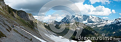 Panoramic view of snowcapped mountains and valley landscape with blue sky and clouds. Stock Photo