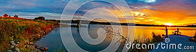 Panoramic view Sports Fishermen at Sunset early fall with beautiful skyline over Ed Zorinsky lake Omaha Nebraska. Water reflection Stock Photo