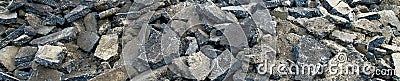 Panoramic view of a stockpile with asphalt piles, which are prepared on the heap for removal to orderly disposal. Stock Photo