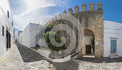 Panoramic view of a street in Vejer de la Frontera and one of the gates of Editorial Stock Photo