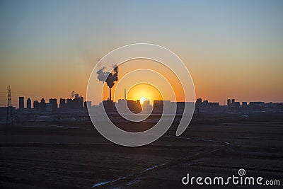 Panoramic view of sunset in the city with silhouette of buildings and industrial factory,pollution city or town concept Stock Photo