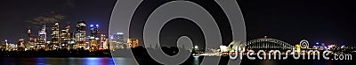 Panoramic view of the Sydney skyline, including the Harbor Bridge and Opera House at night Editorial Stock Photo