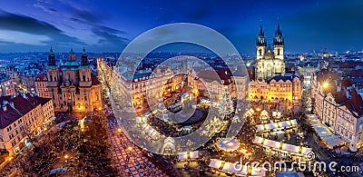 Panoramic view to the old town square of Prague during winter night time with a Christmas Market Editorial Stock Photo