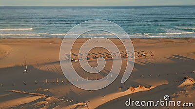 Panoramic view tropical beach ocean surf. Aerial empty recliners and umbrellas Stock Photo
