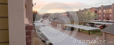 Panoramic view typical apartment complex with detached garage, covered parking lots at sunrise Editorial Stock Photo