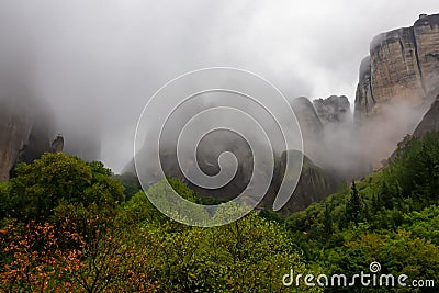 Panoramic view of unique rock formations near mountain Aghio Pnevma (Holy Spirit) on cloudy foggy day in Kalambaka, Meteora Stock Photo