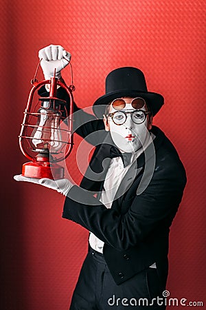 Pantomime actor performing with kerosene lantern Stock Photo