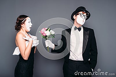 Pantomime actors performing with flower bouquet Stock Photo