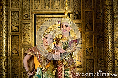 Pantomime Khon is traditional Thai classic masked play enacting scenes from the Ramayana with a backdrop of Thai paintings in a Stock Photo