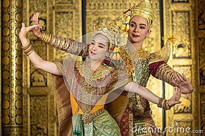 Pantomime Khon is traditional Thai classic masked play enacting scenes from the Ramayana with a backdrop of Thai paintings in a Stock Photo
