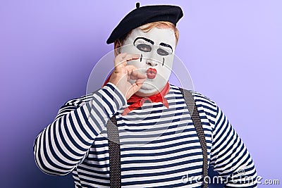 Pantomime theater artist posing, pretending to smoke pipe, cigarette Stock Photo