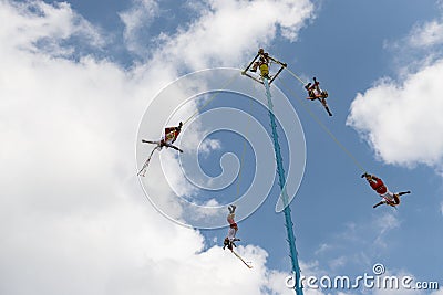 A group of voladores flyers climbing the pole to perform the traditional Danza de los Voladores Dance of the Flyers in Papantl Editorial Stock Photo
