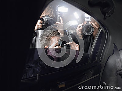 Paparazzi Shooting Through Car Window Stock Photo