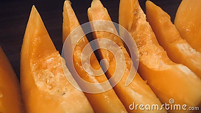 Papaya slices in row on wooden background. Close up view. Stock Photo