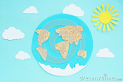 paper application: planet Earth, continents, clouds and the sun on a blue background. Stock Photo