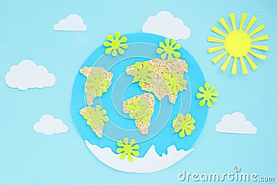 paper application: planet earth, continents, clouds, sun and green viruses around on a blue background. Coronavirus pandemic Stock Photo