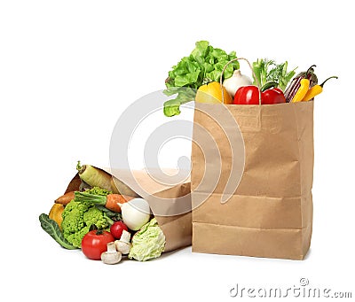 Paper bags with vegetables on white Stock Photo