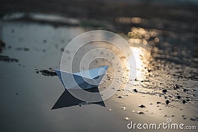 Paper boat on beach on sunset time Stock Photo