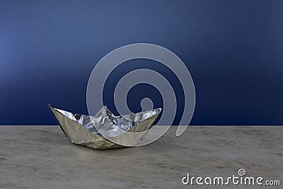 Paper boat made of aluminum foil. Stock Photo