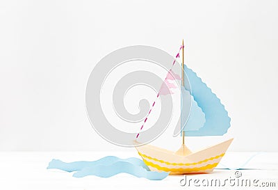 Paper boat made of colored paper on white Stock Photo