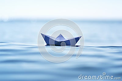 Paper boat on sea wave Stock Photo