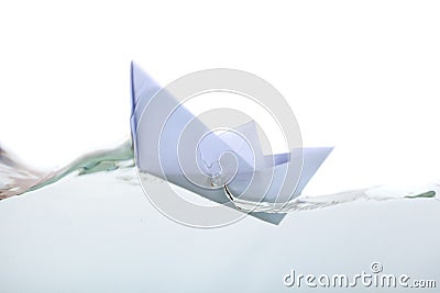 A paper boat in transparent water Stock Photo