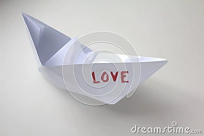Paper boat with the word `love`. Stock Photo