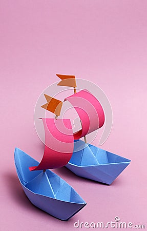 2 paper boats on a pink background Stock Photo