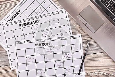 Paper calendars with pen and laptop pc. Stock Photo