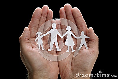 Paper chain family protected in cupped hands Stock Photo