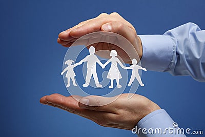 Paper chain family protected in cupped hands Stock Photo