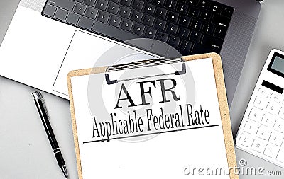 Paper clipboard with AFR on laptop with pen and calculator Stock Photo