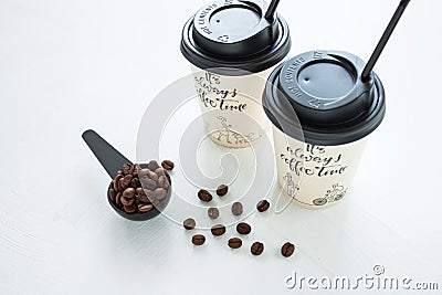 Paper coffee cup from coffee shop with coffee beans near the window. Lifestyle concept Stock Photo