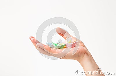 Paper colored boats on a hand on white Stock Photo