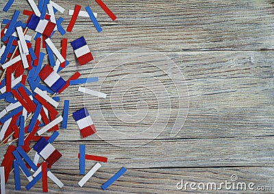 Paper confetti of the national colors of France, white-blue-red on a white wooden background with flags, concept Bastille day, Jul Stock Photo