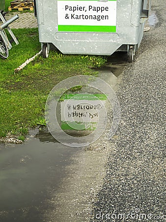 Paper containers by a puddle Stock Photo