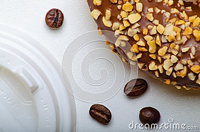 Paper cup for coffee, disposable ecological coffee supplies. Donuts on paper trays. Wooden table. Stock Photo