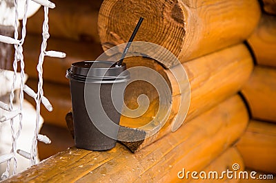 Paper cup with coffee stands on a wooden log Stock Photo