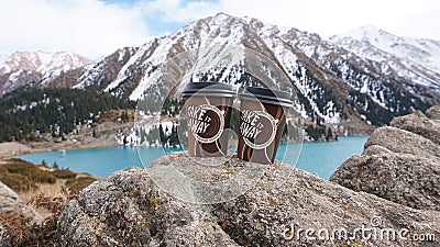 Paper cups on the background of a mountain lake Editorial Stock Photo