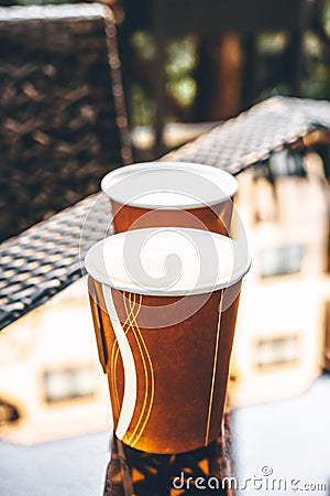 Paper cups with coffee in an outdoor cafe Stock Photo