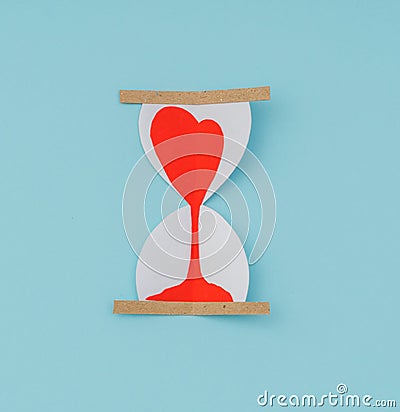 Paper cut of Hearts in Sand Clock . Stock Photo