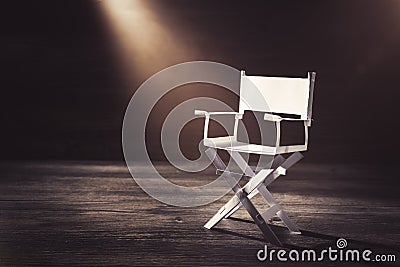 Paper director chair on a blueish grey background Stock Photo