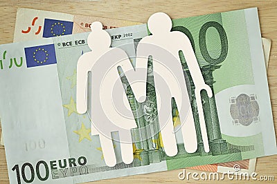Paper elderly couple cut-out on euro banknotes - Pension concept Stock Photo