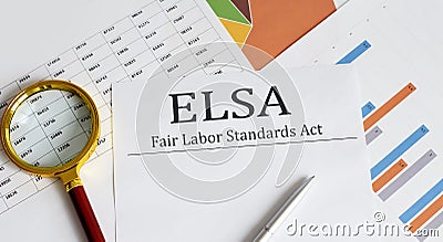 Paper with Fair Labor Standarts Act FLSA on a table with pen, charts and magnifier Stock Photo